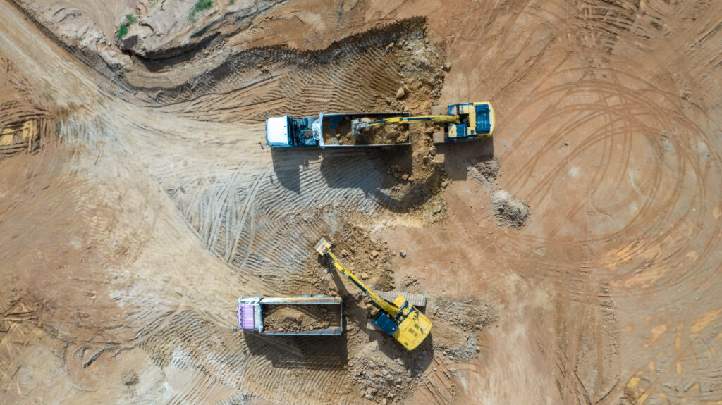 aerial-view-excavators-and-trucks-working-at-construction-site